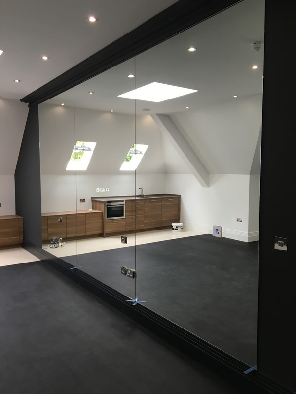 Frameless glass partition in loft conversion by Finsbury Park glaziers