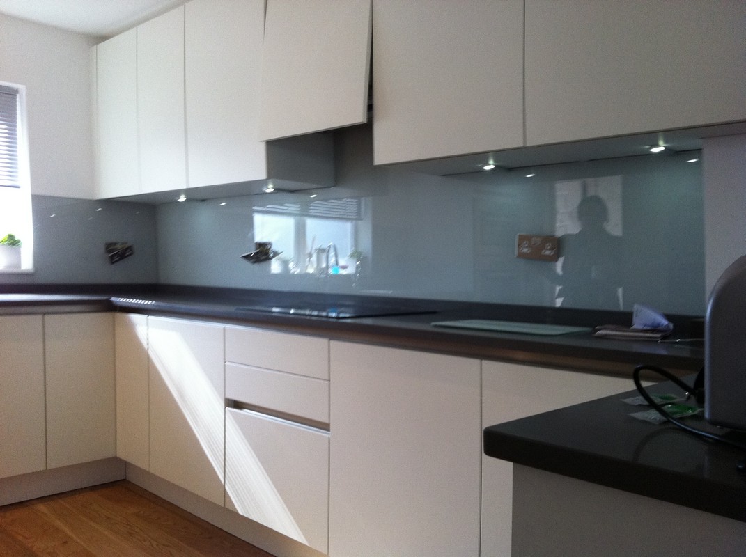 Grey glass kitchen splashback with LED lighting in Finsbury Park